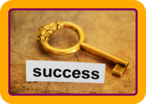 Gold key with round fob and the word success underneath