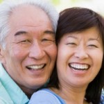 Older Asian man and woman smiling and laughing